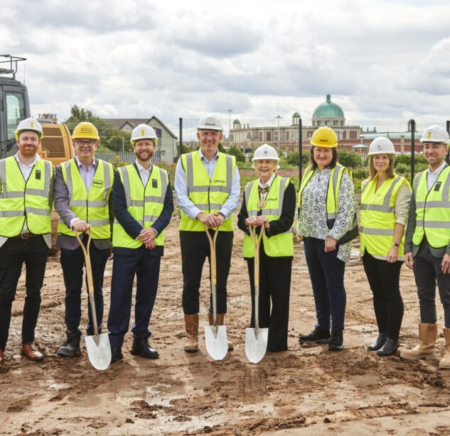 Staff picture with hart hats and high vis vests on the Trafford Waters building site